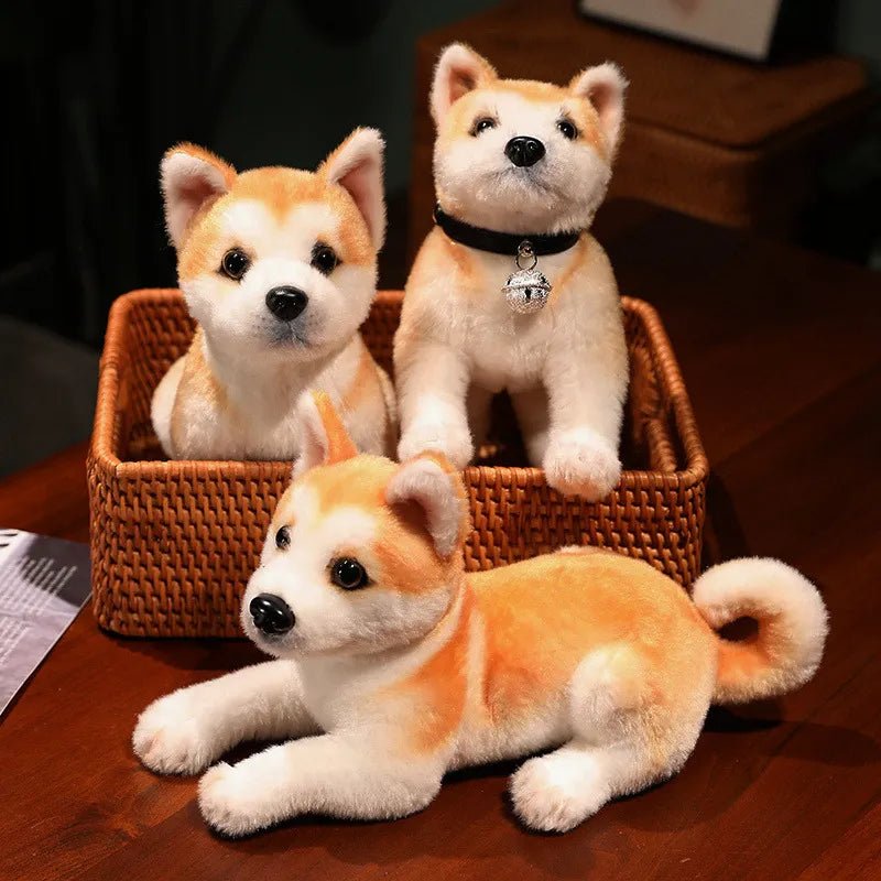 Three plush Shiba Inu dogs in a woven basket on a wooden surface.