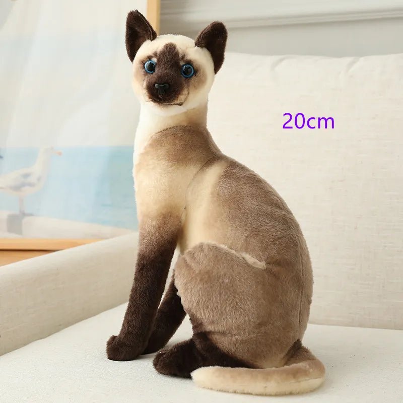 Plush toy cat sitting on a surface with a blurred background