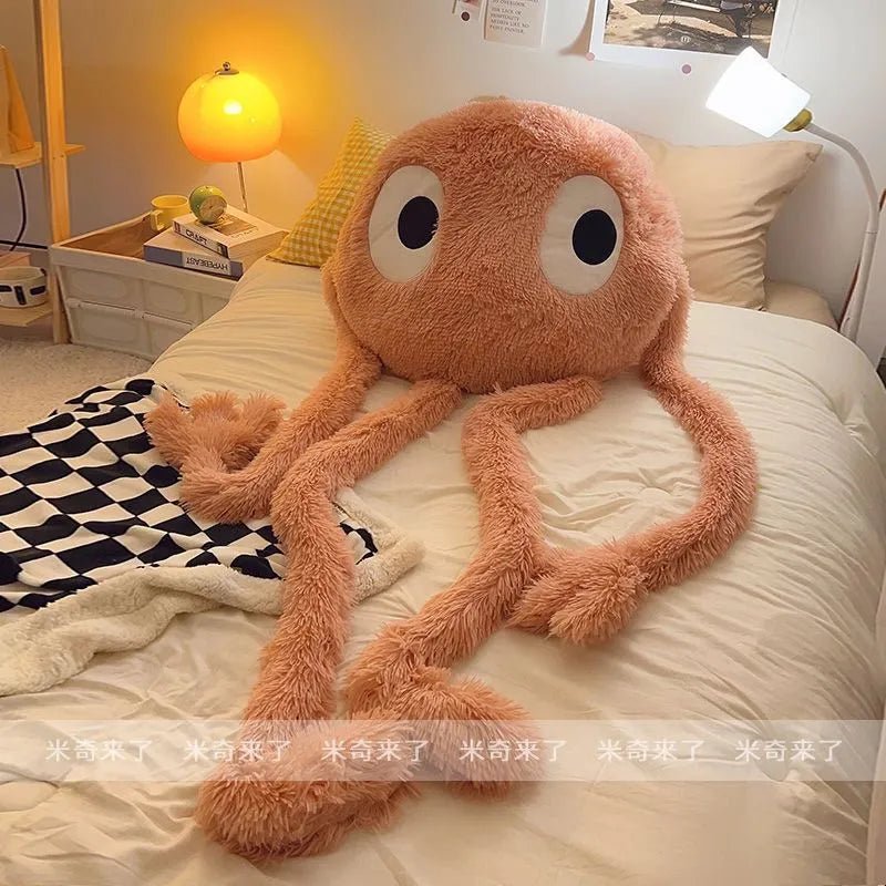 Plush octopus toy on a bed in a bedroom setting