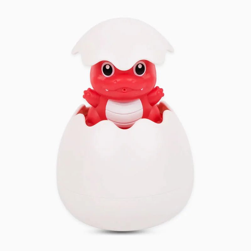 Red dinosaur toy emerging from a white egg on a white background