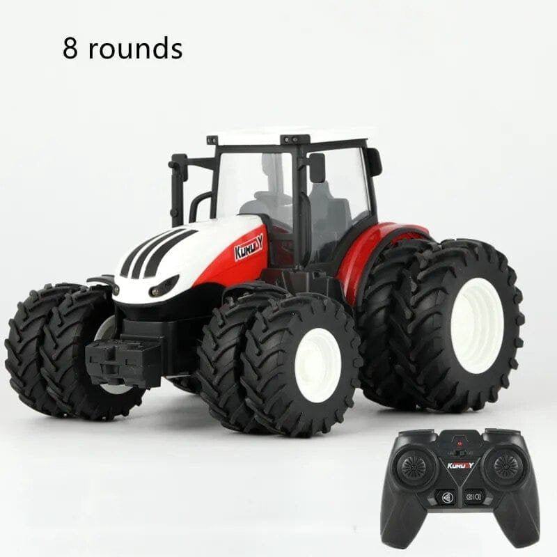 Toy tractor with large wheels and a remote control.