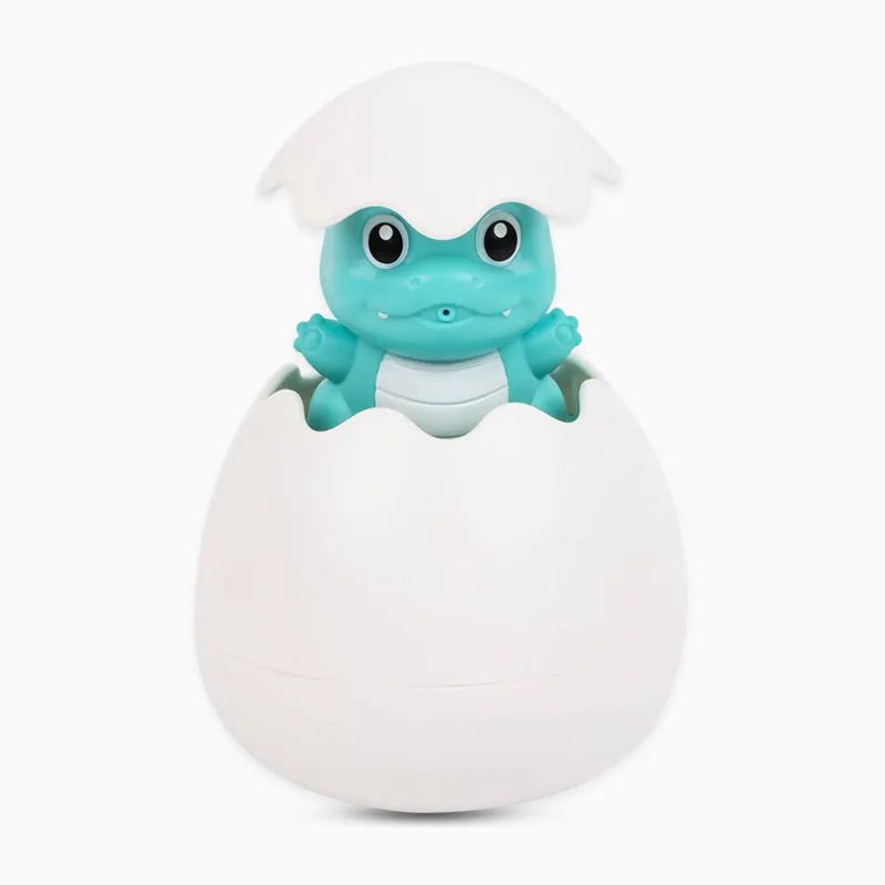 Toy frog emerging from a white egg on a white background