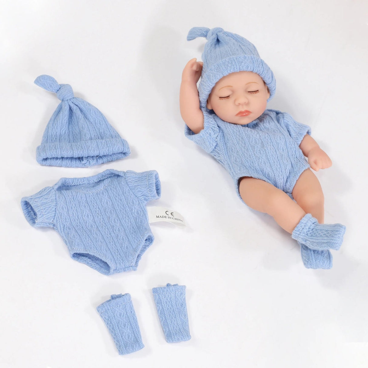 Set of blue baby clothing, including a hat, romper, and leg warmers.