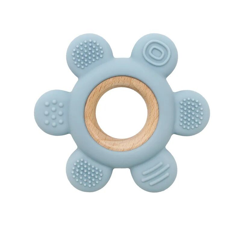 Blue teething ring with wooden center on a white background