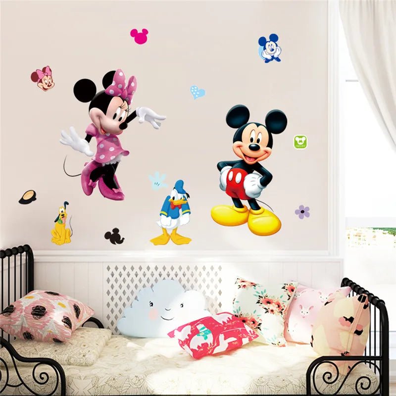 Cartoon character wall decals on a wall with a bed and pillows below.