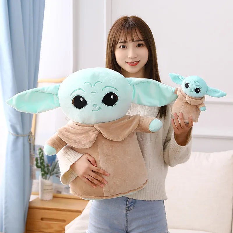 Person holding two plush toys resembling a character from a popular franchise.