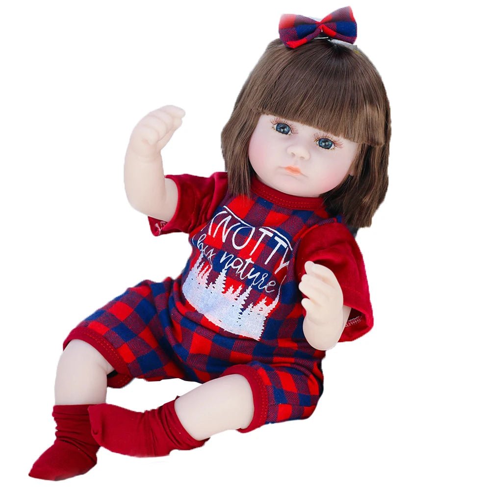 A doll wearing a red and blue outfit with a bow.