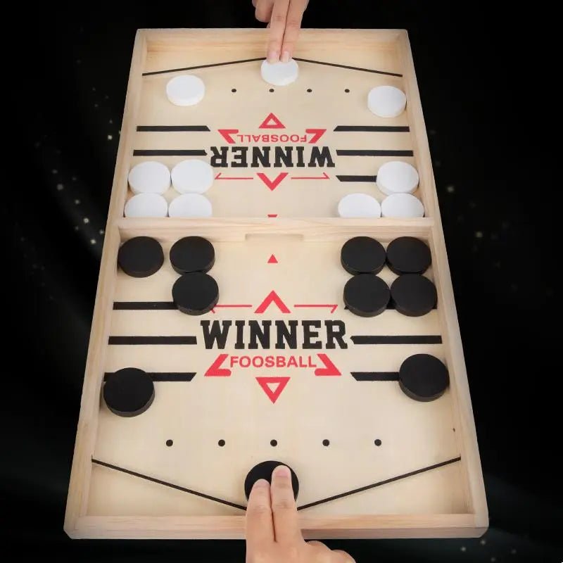 Wooden foosball table with 'Winner' branding on a black background