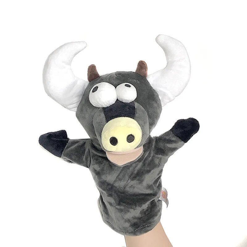 Plush bull puppet with a hand holding it against a white background