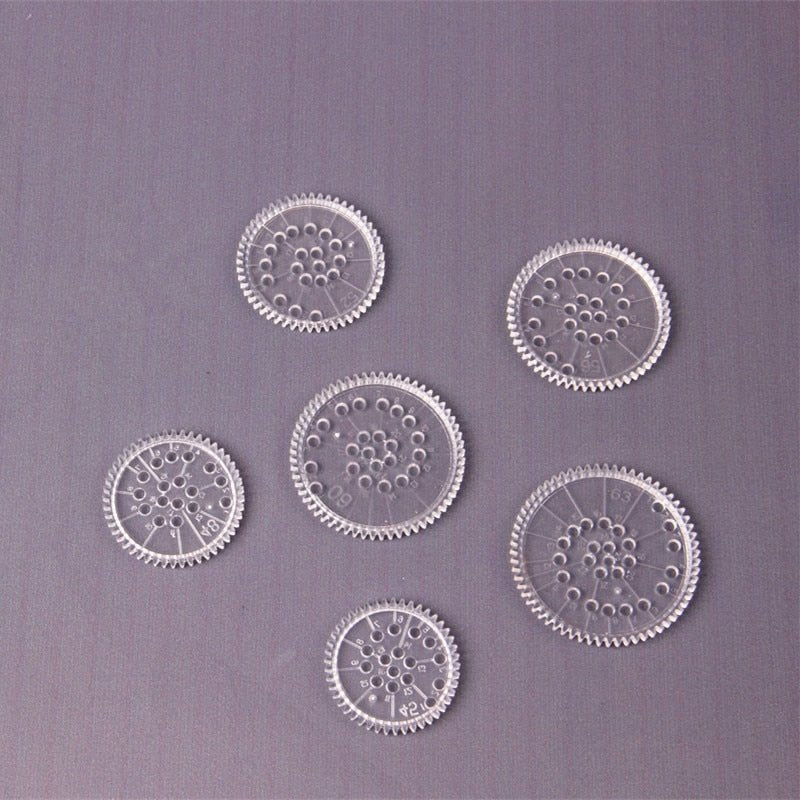 Set of six transparent plastic gears on a purple background
