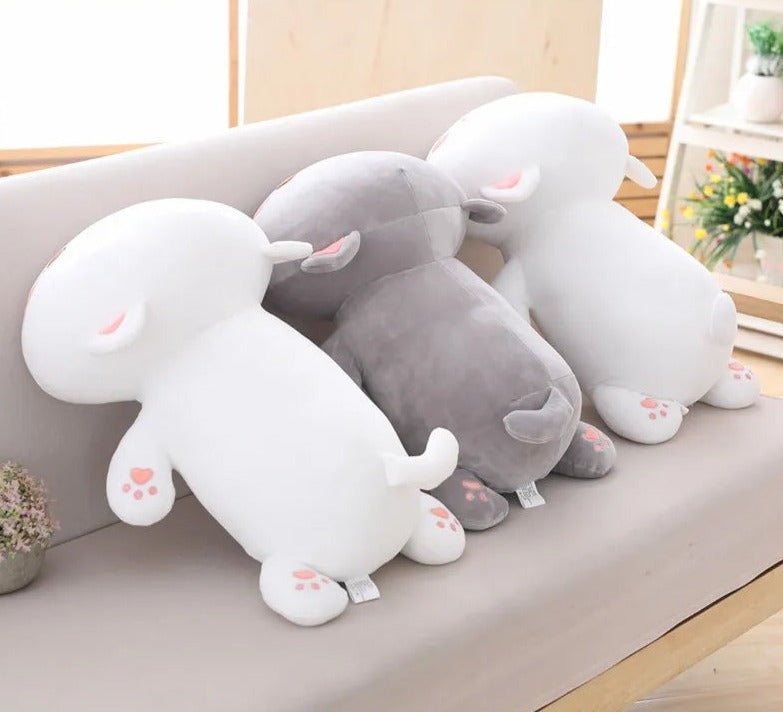 Set of plush animal toys on a light surface with a blurred indoor background