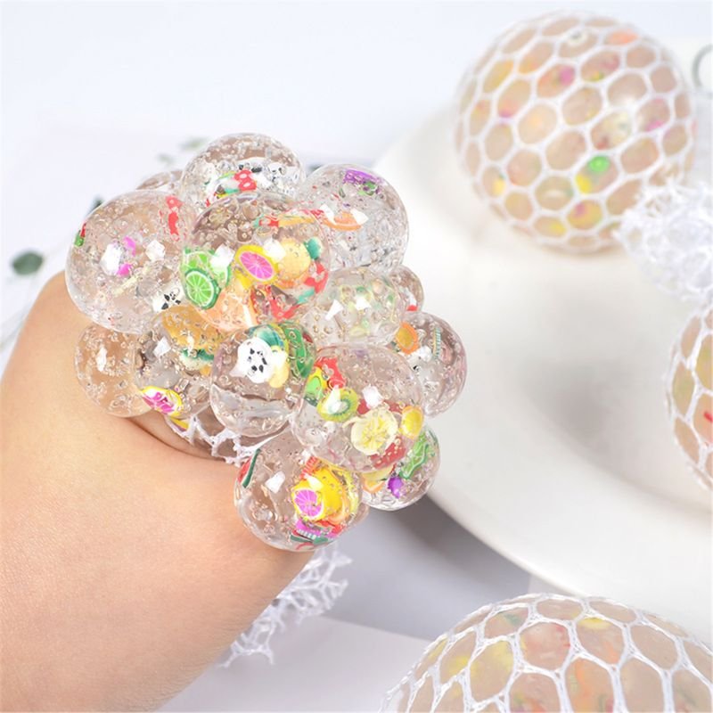 Colorful gelatinous ball with embedded toys.