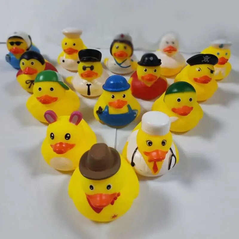 Set of yellow rubber ducks with various hats on a white background.