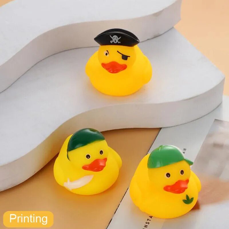 Three yellow rubber ducks with hats on a white surface.
