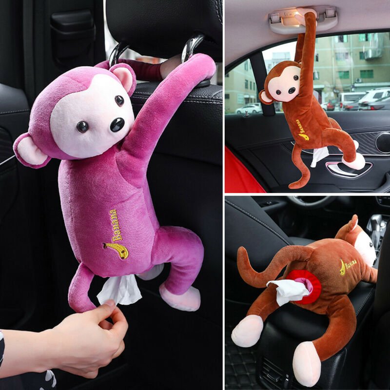 Collage of plush monkey car hangers in pink and brown, with one being held by a hand.