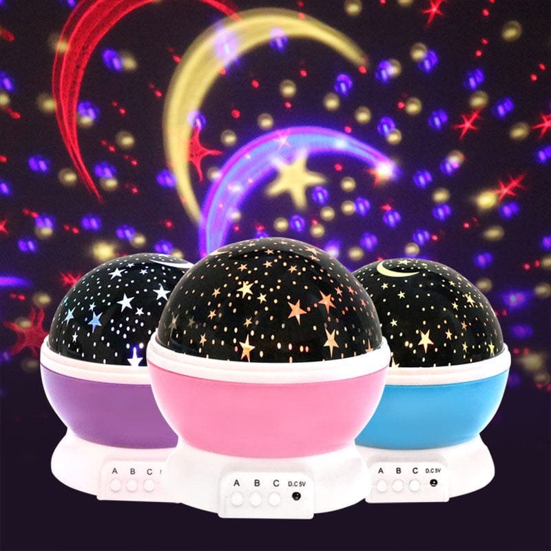 Three colorful night lights projecting starry patterns on a dark background