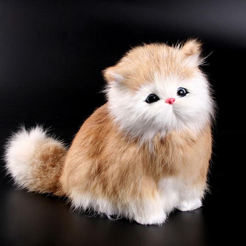 Plush toy cat with brown and white fur on a black background