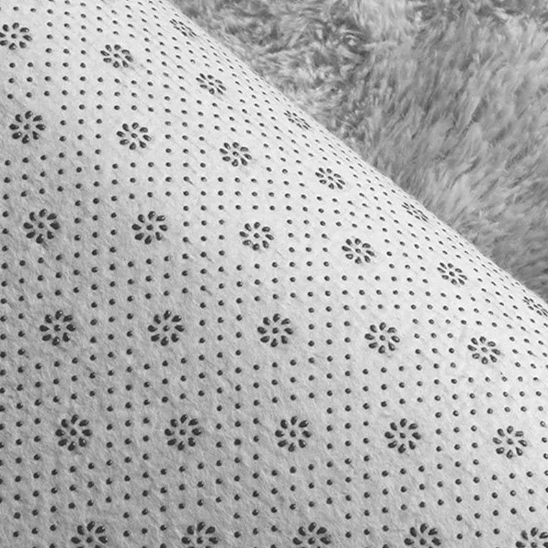Close-up of a textured white fabric with black floral patterns.