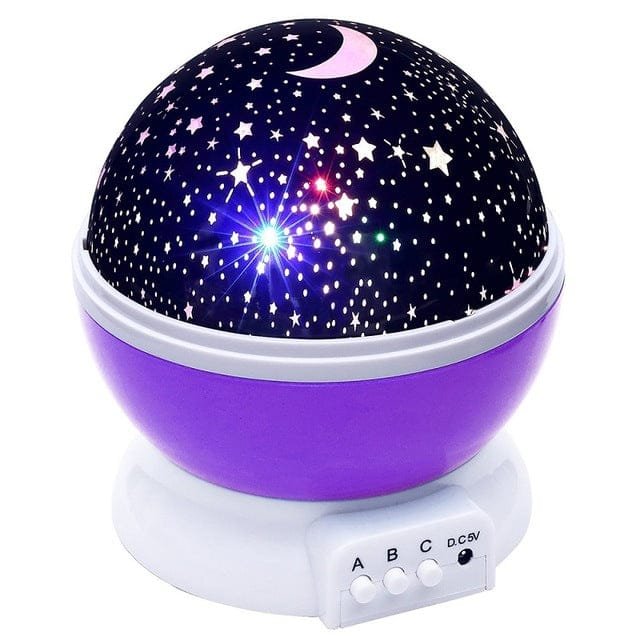 Purple and black starry night light projector on a white background