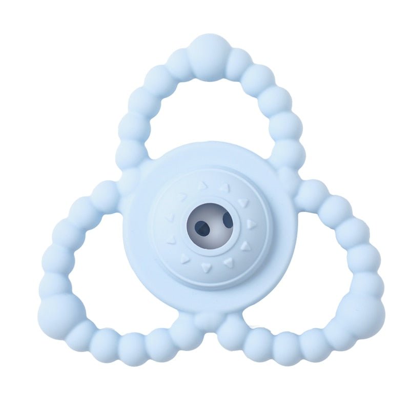 Light blue teething ring with a circular design on a white background
