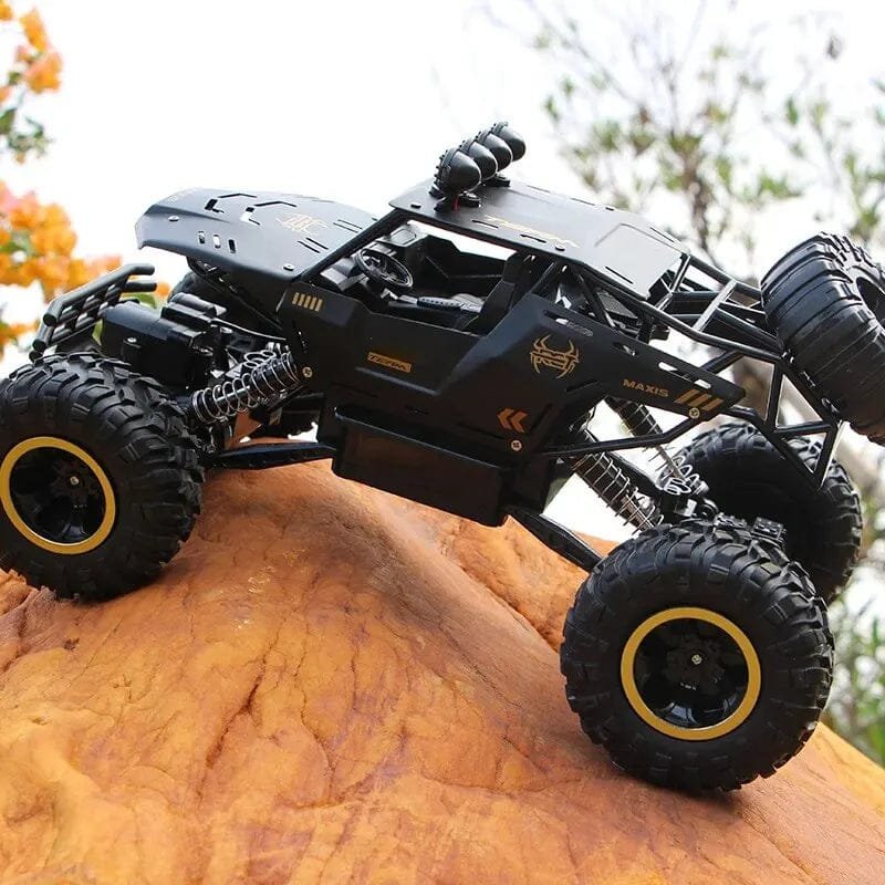 Black off-road vehicle with large tires on a rock
