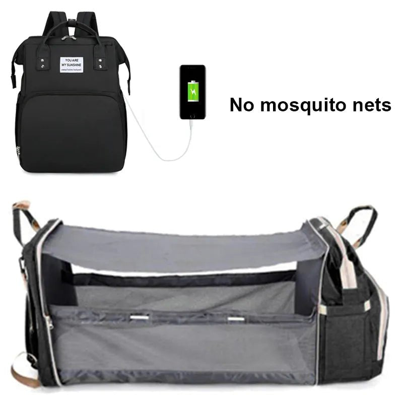Black backpack with charging cable and gray baby crib.