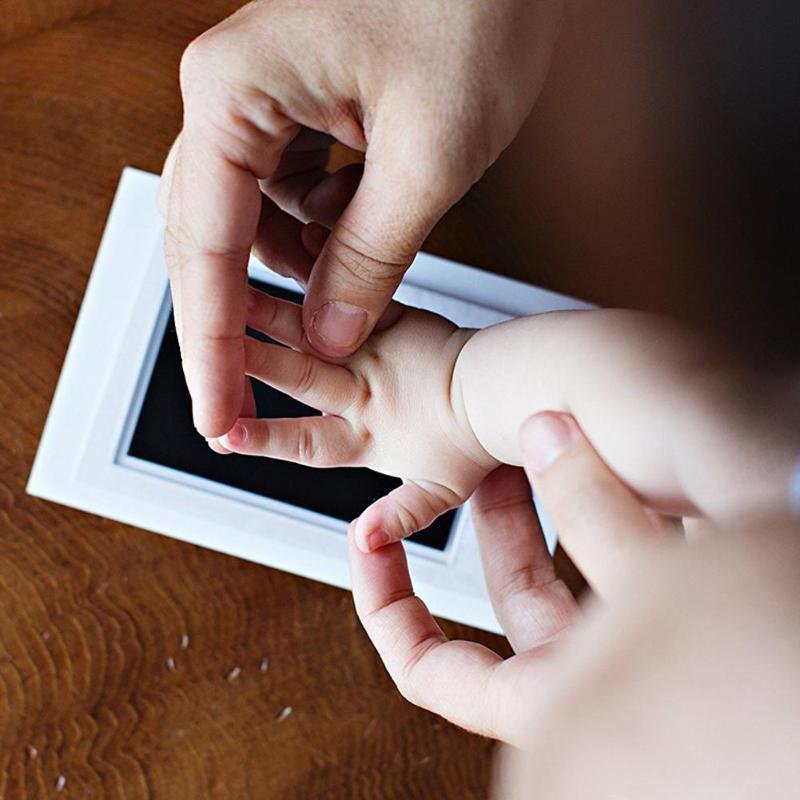 Close-up of a baby's hand being held by an adult's hand
