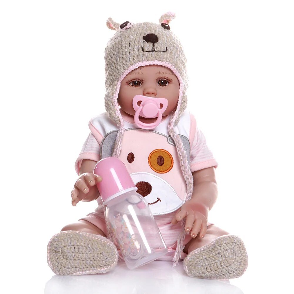 Baby doll in a bear costume holding a pink bottle.