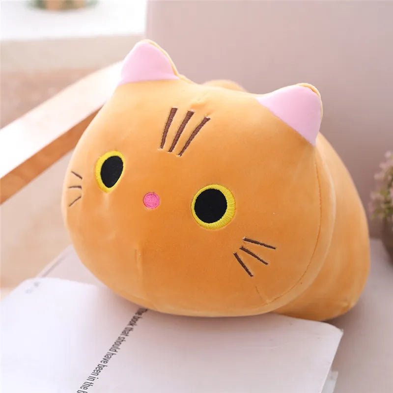 Plush cat pillow on a surface