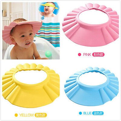 Baby shower caps in pink, yellow, and blue with a child in a bathtub.