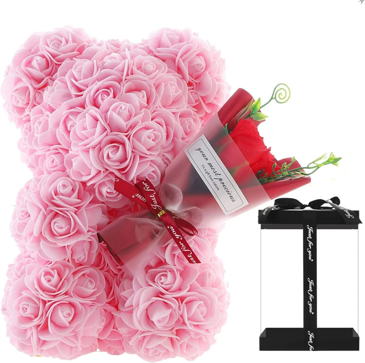 Pink rose teddy bear with a red ribbon and gift box.