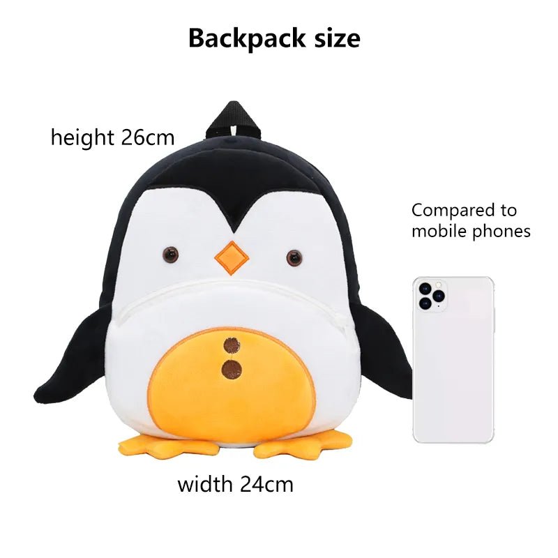 Penguin-shaped backpack with dimensions and a comparison to a mobile phone.