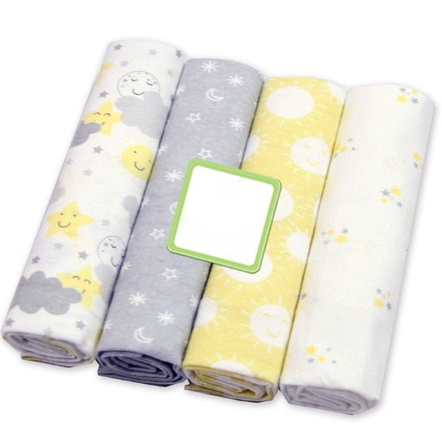 Four rolls of fabric with star, moon, and cloud patterns.