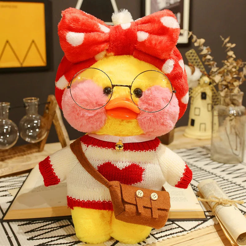 Plush toy duck with a red bow and glasses on a decorative surface