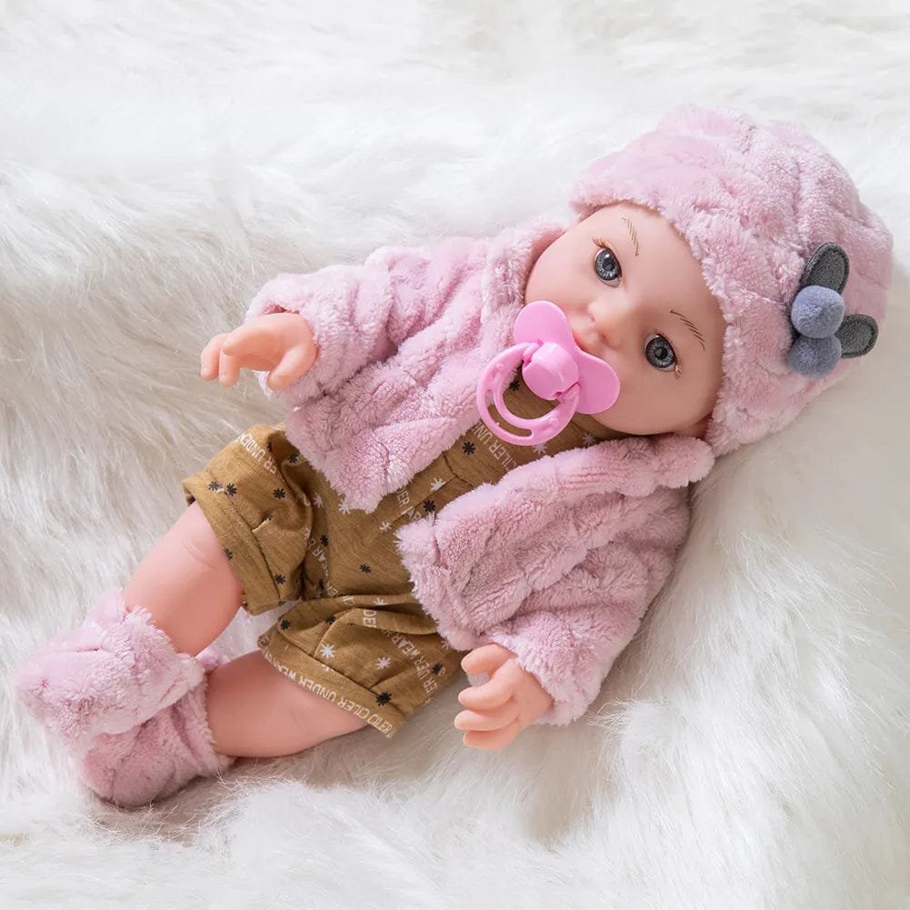 Baby doll in pink outfit with pacifier