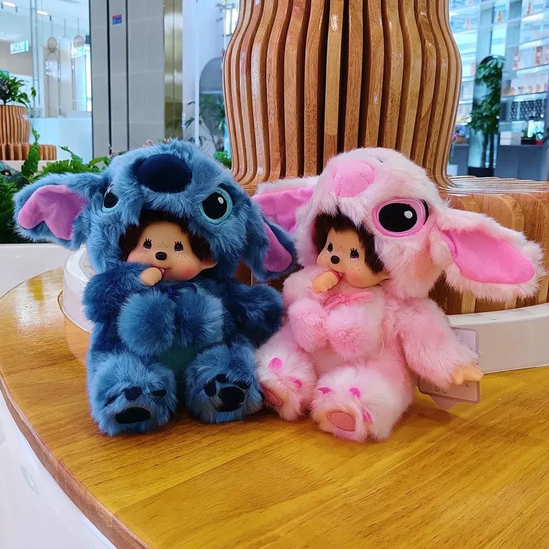 Two plush toys, one blue and one pink, sitting on a wooden table.