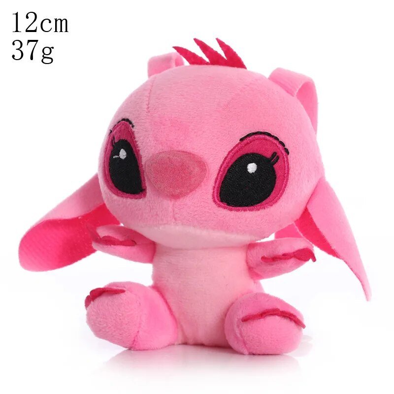 Small pink plush toy with black eyes