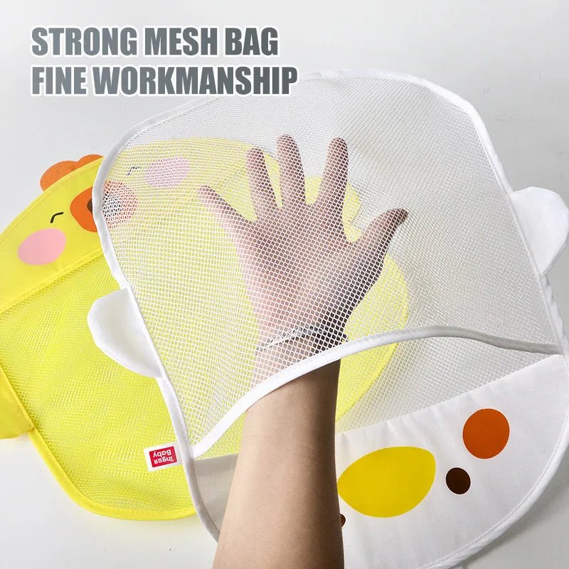 Child's hand holding a yellow and white mesh bag with cartoon design.