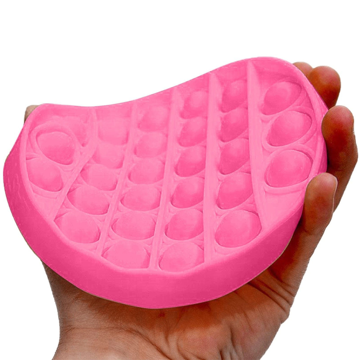 Pink silicone cushion with bubble texture held in a hand against.