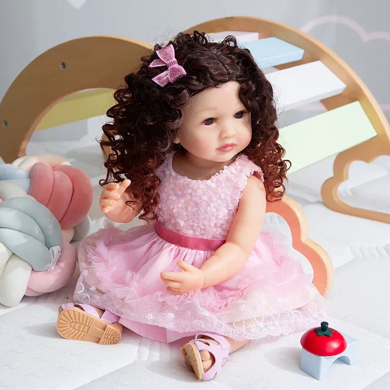 A doll with curly hair and a pink dress