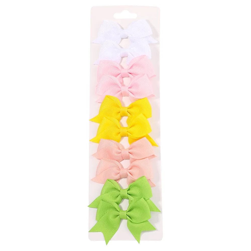 Set of colorful hair bows in a clear packaging on a white background