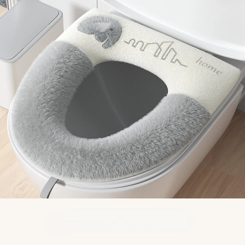 Gray toilet seat cover with 'home' branding on a toilet.