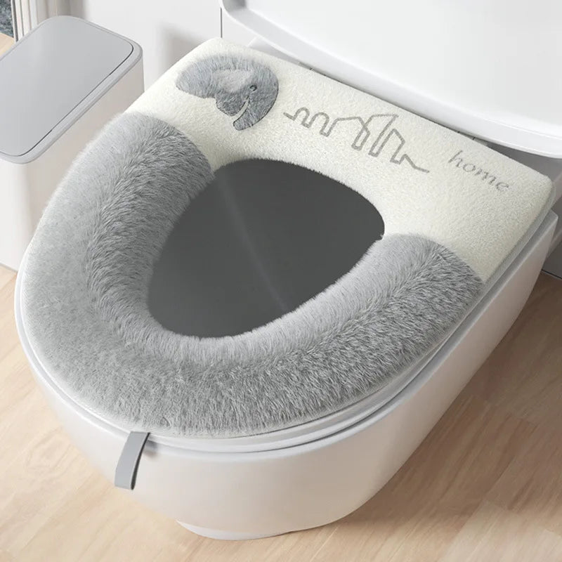Gray toilet seat cover on a toilet with 'home' branding.
