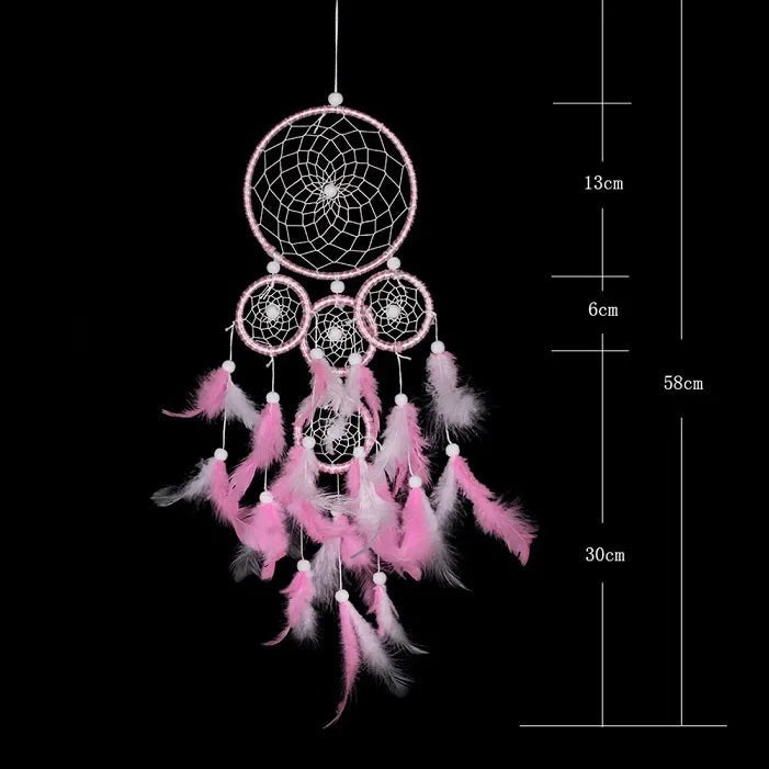 Pink dreamcatcher with feathers, accompanied by measurements.