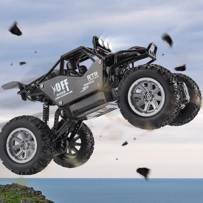 Black RC off-road vehicle in mid-air with a blue sky