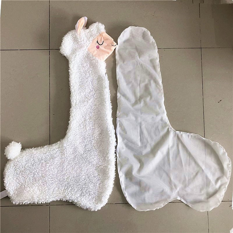 White plush llama toy and transparent plastic cover on a tiled floor