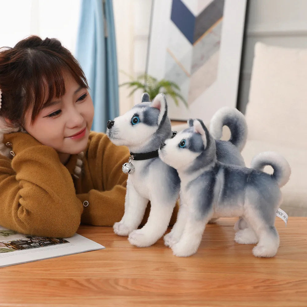 Woman with two husky plush toys.