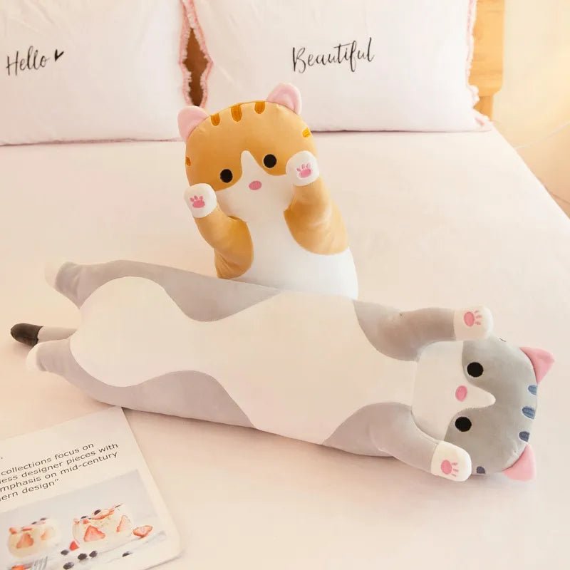 Cute cat-shaped plush toy on a white surface.