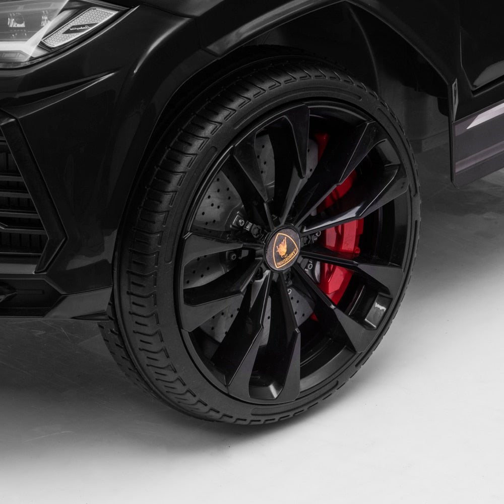 Close-up of a black Lamborghini wheel with red brake caliper.