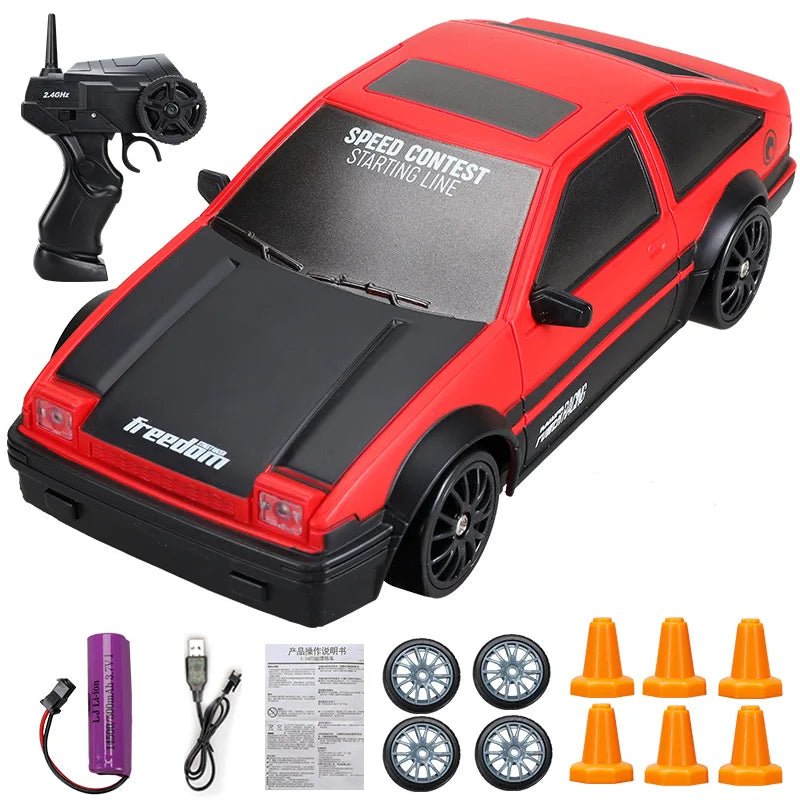 Red and black toy car with remote control, batteries, and cones.